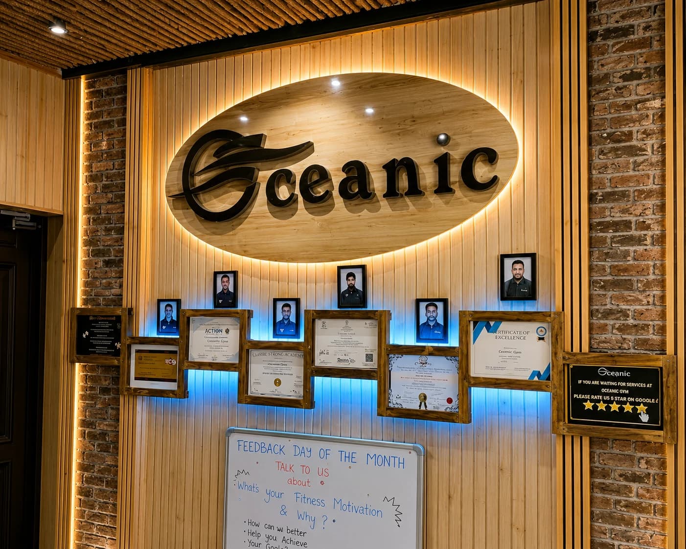 Oceanic Gym reception wall with brand sign and trainer certifications